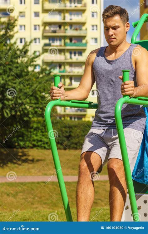 Man Doing Sit Ups in Outdoor Gym Stock Photo - Image of adult, male: 160104080