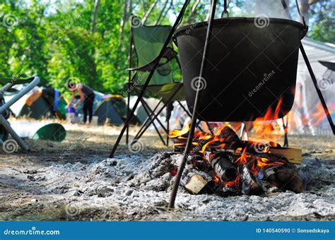 Cooking in a cauldron stock photo. Image of meal, metal - 140540590