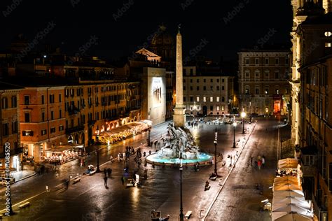 View from a window overlooking Piazza Navona at night showing the ...