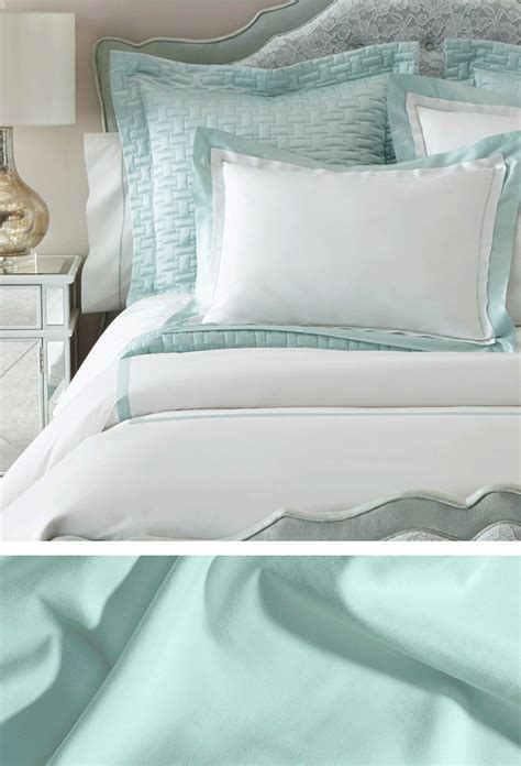 two pictures of a bed with white and blue sheets