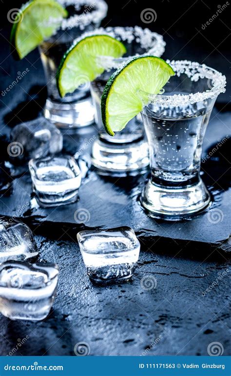 Silver Tequila Shots with Ice and Lime on Black Table Background Stock Image - Image of cubes ...