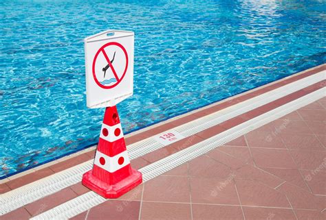 Premium Photo | No diving prohibition sign standing near a swimming pool