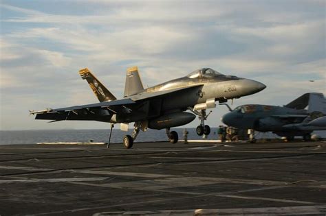 Hook Down! F/A-18E Super Hornet landing over an Aircraft Carrier.