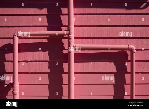 painted pink plumbing pipes on building on Catalina Island CA Stock Photo - Alamy