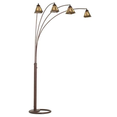 a floor lamp with five lights on it and four lamps hanging from the top,
