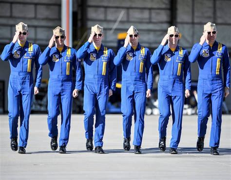 Pilots assigned to the U.S. Navy Flight Demonstration Squadron, the Blue Angels, walk down the ...