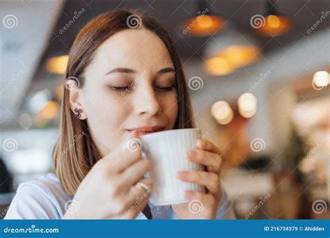 Portrait of Young Woman Drinking Coffee at Table in Cafe Stock Image ...