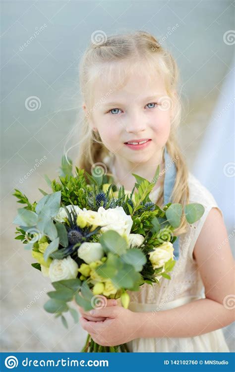 Adorable Little Bridesmaid Holding Beautiful Flower Bouquets after Wedding Cemerony Outdoors ...
