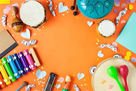 Premium Photo | Table top view kids music instruments on orange ...