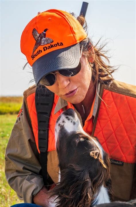 PHOTO Kristi Noem Kissing A Dog With An Orange South Dakota Hat On