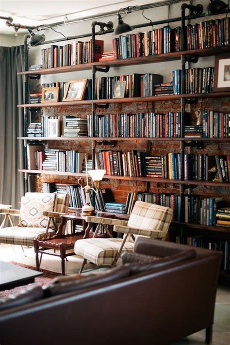 a living room filled with lots of furniture and bookshelves full of ...