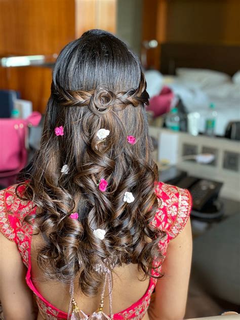 Photo of Open hairstyle with soft curls and flowers.