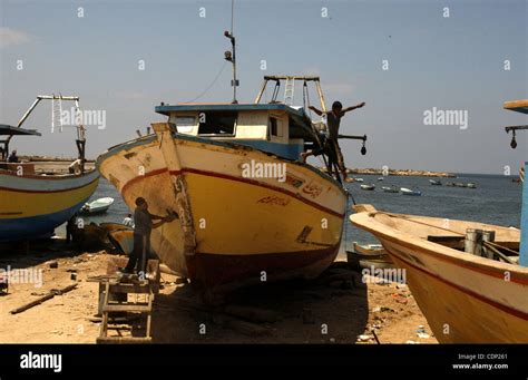 Palestinian fishermen prepare their boats for fishing at Gaza beach on ...