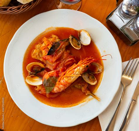 Gourmet seafood tapas. Delicious monkfish tail stewed in tomato sauce ...