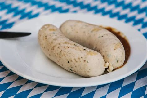 Traditional Bavarian sausages on a plate with sauce. Celebrating the ...