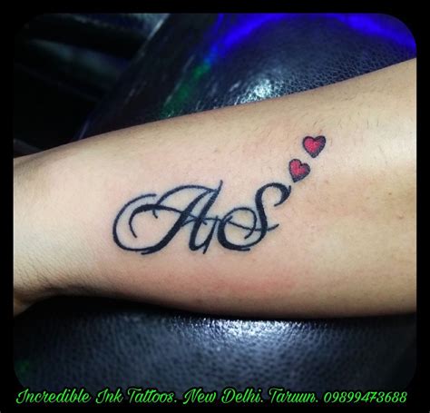 an arm tattoo with hearts and the word aos written in cursive writing