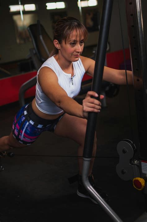 Photo of Woman Working out Using Gym Equipment Inside Gym · Free Stock Photo