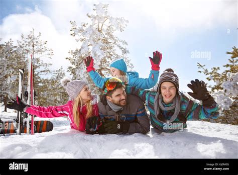 Happy family having fun on snow on winter holiday Stock Photo - Alamy