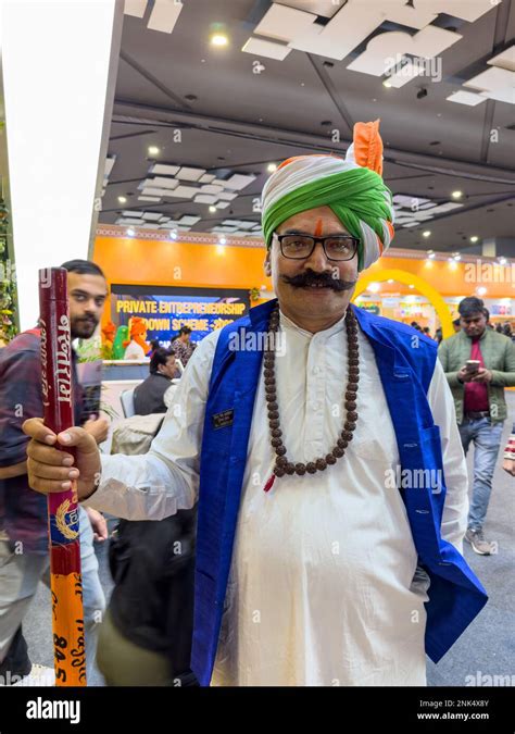 Portrait of an male from haryana in traditional white dress and colorful tri colour turban on ...