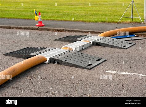 Hose ramps over high volume pump hose at fire Stock Photo - Alamy