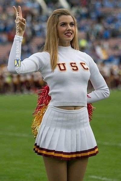 a cheerleader is posing for the camera