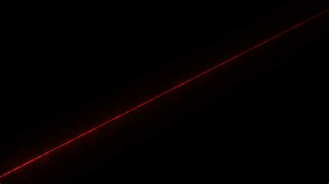 A red laser beam shines diagonally on a black background 15231359 Stock ...