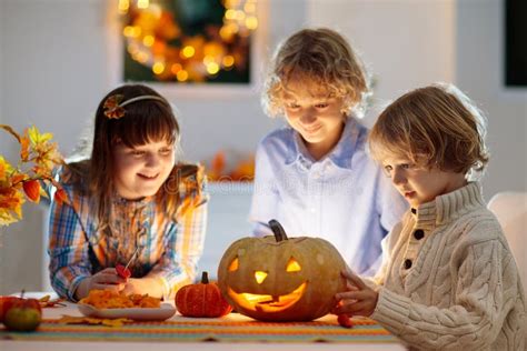 Family Carving Pumpkin for Halloween Stock Photo - Image of harvest, fireplace: 256456392