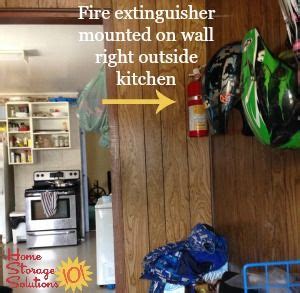 Fire extinguisher mounted on wall by the kitchen, example of good fire ...