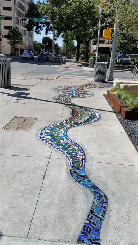 a sidewalk that has been decorated with colorful tiles on the side and ...