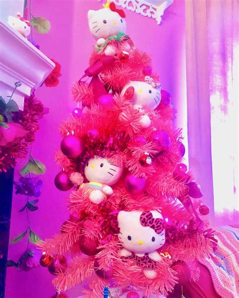 a pink christmas tree with hello kitty ornaments