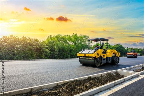 Construction site is laying new asphalt road pavement,road construction workers and road ...