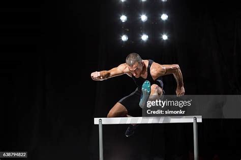 97 Male Athletes Jumping Over Hurdles Front View Stock Photos, High-Res Pictures, and Images ...