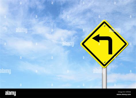 Road Sign - Left Turn Warning with blue sky blank for text Stock Photo - Alamy