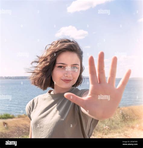 Beautiful happy young woman making stop sign with her hand Stock Photo - Alamy