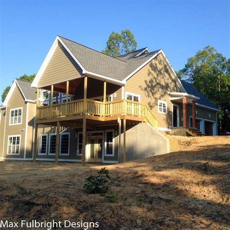 Butlers Mill is a cottage style lake house plan with a walkout basement and garage. An open ...