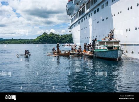 Locals approach anchored cruise ship to sell wares or solicit. Nosy Be ...