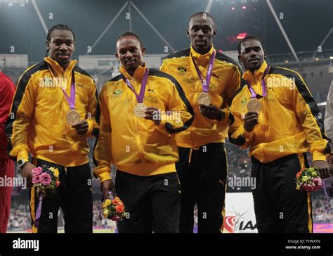 The Jamaican Men's 4x100 relay team hold their gold medals after setting a new world record time ...