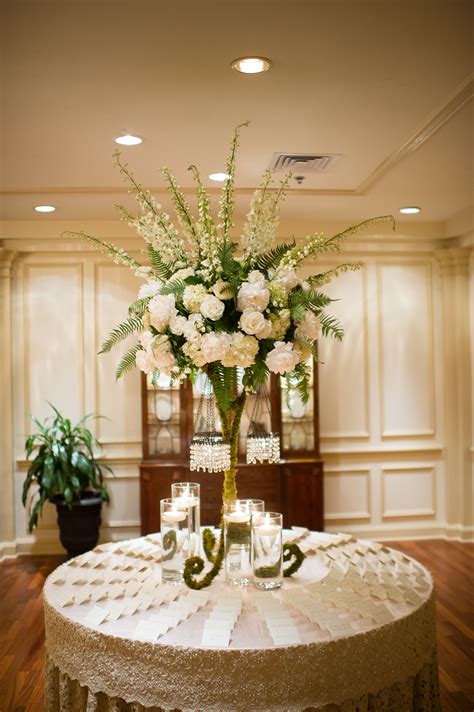 Tall Flower Arrangement With Ivory Roses and Delphiniums | Tall flower arrangements, Wedding ...