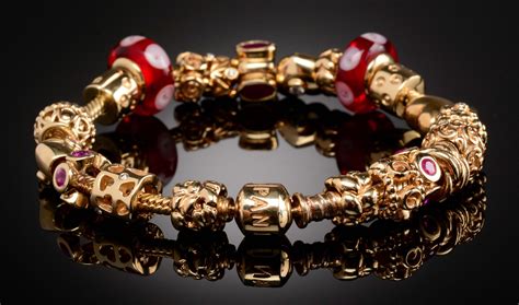 Lot Detail - 14K GOLD PANDORA BRACELET WITH 21 CHARMS & CLIPS.