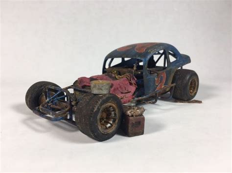 an old rusty toy car with rusted parts on it's body and wheels