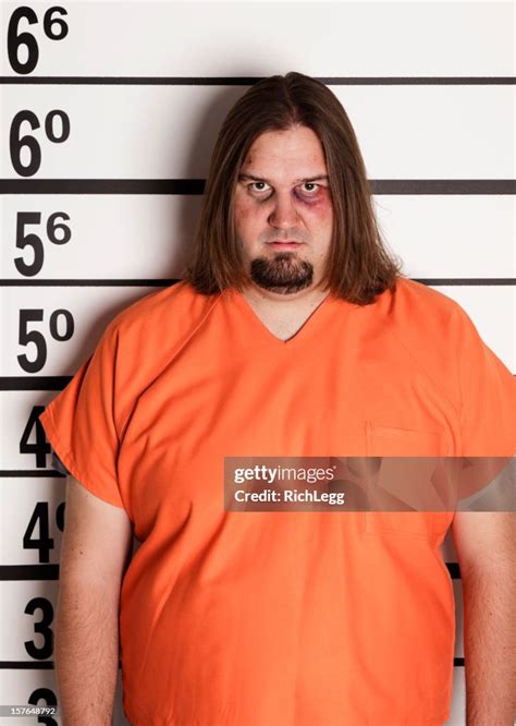 Mugshot Of A Large Man In Prison Uniform High-Res Stock Photo - Getty Images