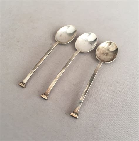 3 small silver spoons