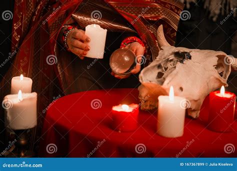 A Woman Holds a Candle To Perform a Magical Ritual. the Witch Casts a Spell Stock Image - Image ...