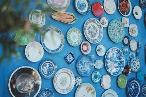 Decorative ceramic plates on blue wall · Free Stock Photo