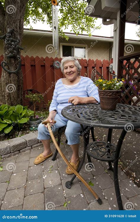 Senior Woman Sitting in Garden Stock Photo - Image of home, independent: 31091628