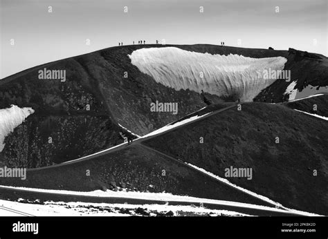 black and white photography cinder cone of volcano and silhoutte people ...