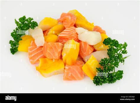 Mixed group of fresh raw salmon, cod and smoked haddock chunks prepared ...