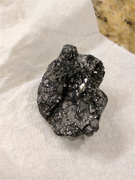 Found shiny black rock on the beach in south Florida. Any ideas? : r ...