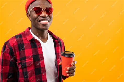 Premium Photo | Stylish black American man with a beautiful smile in a checkered red shirt holds ...