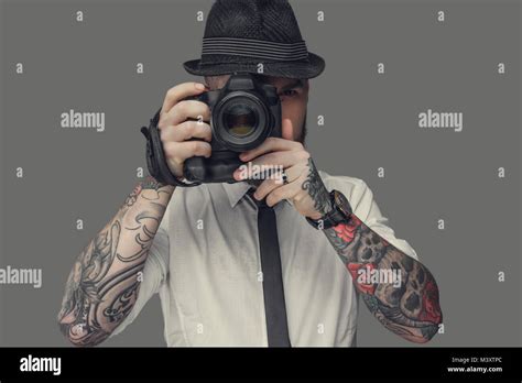 A man with dslr isolated on grey background Stock Photo - Alamy